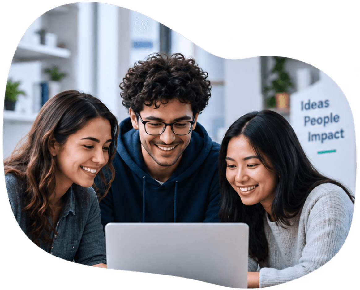 Three students smiling at a laptop together